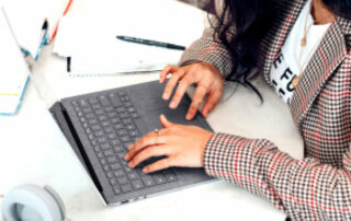 Loan officer working on a mortgage application with a laptop on a table.