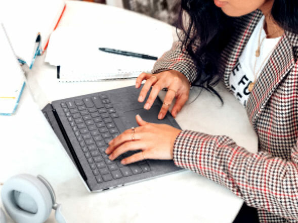 Loan officer working on a mortgage application with a laptop on a table.